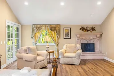 a living room with two chairs and a fireplace at #Marbella Lane - Tranquil Country Escape Getaway in Placentia