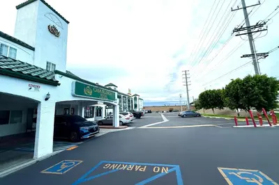 a street in a town with a parking lot at Casa Blanca Hotel - Corona in Corona