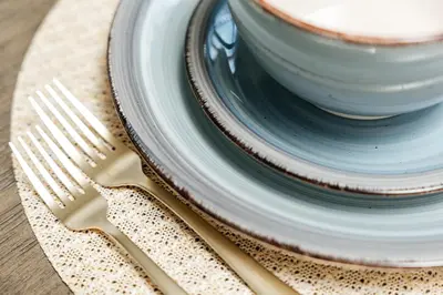 a plate with a cup of coffee and a fork at Stunning 2BR apartment steps from Santa Monica pier in Los Angeles