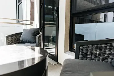 a balcony with a couch and a glass table at Stunning 2BR apartment steps from Santa Monica pier in Los Angeles
