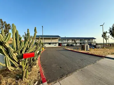 a cactus on the side of a road in front of a building at Circle Inn Hotel - Jurupa Valley Riverside 60 Fwy in Riverside