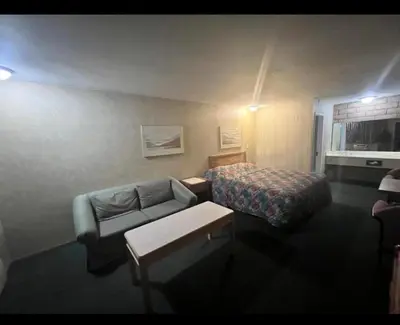 a hotel room with a bed and a couch at Circle Inn Hotel - Jurupa Valley Riverside 60 Fwy in Riverside