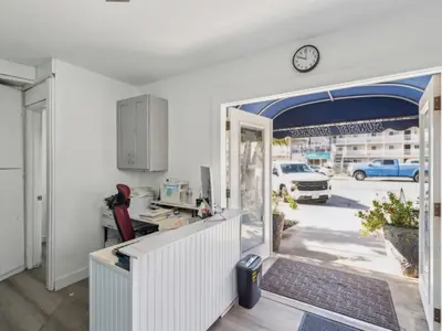 a kitchen with an open door to a garage at Beautiful 2 Bed Beach Condo #104 in Carpinteria