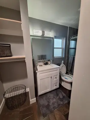 a bathroom with a white sink and a toilet at My amazing home in Azusa