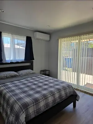 a bedroom with a bed and a large window at WG House Winnetka Los Angeles in Winnetka