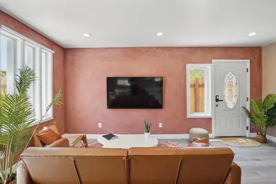 a living room with a couch and a table at La Tierra House 15 Min to Beach Movie Lounge in Hawthorne