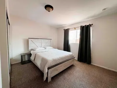 a bedroom with a large bed and a window at Urban Casita in Los Angeles