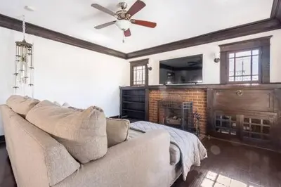 a living room with a couch and a ceiling fan at Urban Casita in Los Angeles