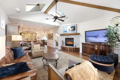 a living room with couches and a large tv at Seventh Shore Stylish Seal Beach Home w Elevator Fireplace Bold Design in Seal Beach