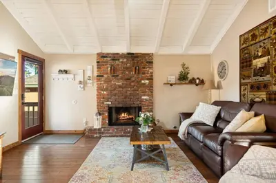 a living room with a couch and a fireplace at Alpine Crest in Big Bear Lake in Big Bear Lake
