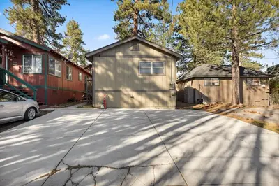 a garage with a car parked in a driveway at Alpine Crest in Big Bear Lake in Big Bear Lake