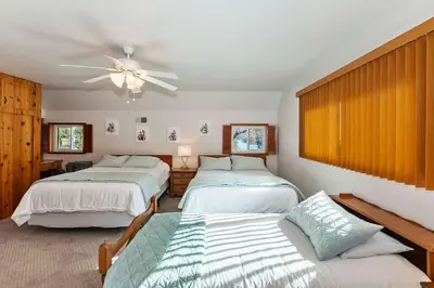 a bedroom with two beds and a ceiling fan at Acorn Acres - Lake Views for 8 in Lake Arrowhead