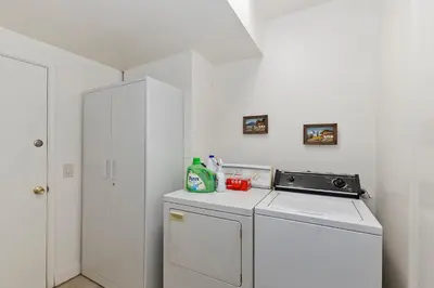 a kitchen with a white refrigerator and a washer at Acorn Acres - Lake Views for 8 in Lake Arrowhead