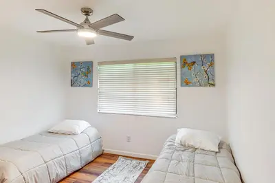 a bedroom with two beds and a ceiling fan at 7 Mi to Dtwn Poolside Paradise in Bakersfield! in Bakersfield