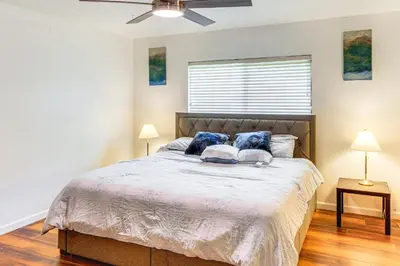 a bedroom with a bed with two pillows on it at 7 Mi to Dtwn Poolside Paradise in Bakersfield! in Bakersfield