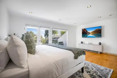 a white bedroom with a large bed and windows at Belden View in Los Angeles