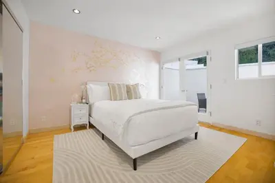 a white bedroom with a white bed and a window at Belden View in Los Angeles