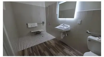 a bathroom with a toilet and a sink at Crestridge Inn Near LAX, SoFi Stadium & Intuit Dome in Inglewood
