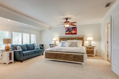 a bedroom with a bed and a blue couch at Chic Coastal Home with Outdoor Oasis in Oxnard! in Oxnard