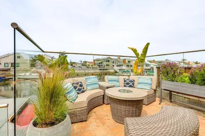 a patio with chairs and a table on a balcony at Chic Coastal Home with Outdoor Oasis in Oxnard! in Oxnard