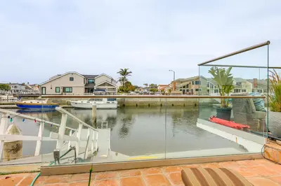 a view of a marina with a boat in the water at Chic Coastal Home with Outdoor Oasis in Oxnard! in Oxnard