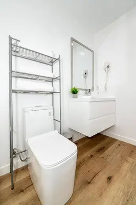 a white bathroom with a toilet and a sink at NoHo Home Near Universal Studios in Burbank