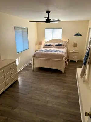 a bedroom with a bed and a dresser and two windows at Recreation Ridge-Next To Boulder Bay-HUGE in Big Bear Lake