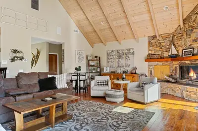 a living room with a couch and a fireplace at Bearfoot Lodge near Hiking & Skiing in Lake Arrowhead