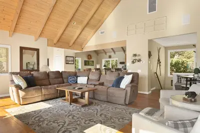 a living room with a couch and a table at Bearfoot Lodge near Hiking & Skiing in Lake Arrowhead