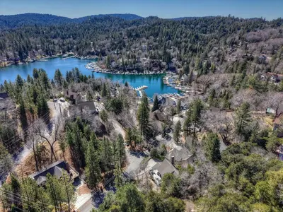 an aerial view of a lake with houses and trees at Bow N Arrow Lodge For 8 in Lake Arrowhead