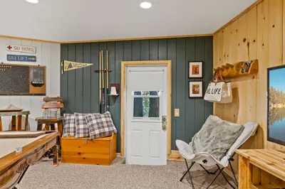 a room with a table and a chair and a door at Chalet Vino - Snow Valley Mountain Resort in Green Valley Lake