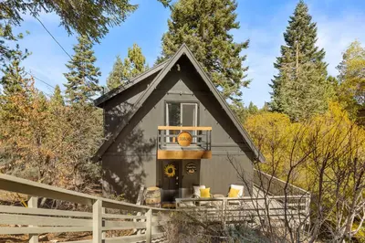 a tiny house with a basketball on the porch at Chalet Vino - Snow Valley Mountain Resort in Green Valley Lake