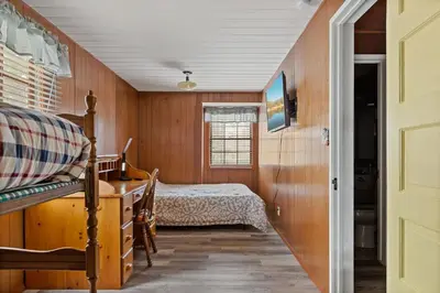a bedroom with a bed and a dresser at Happy Bear Cabin - Hike Bike & More in Big Bear Lake