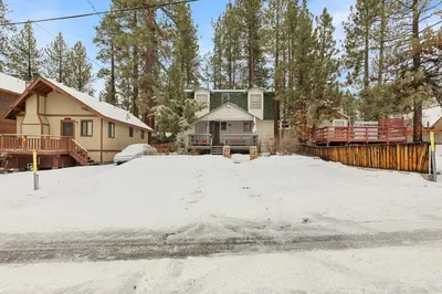 a snow covered driveway with a house in the background at Happy Bear Cabin - Hike Bike & More in Big Bear Lake