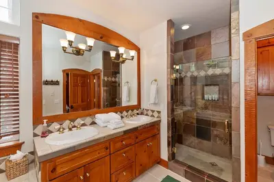 a bathroom with two sinks and a shower at Matternhorn Peak Lodge - For 10 in Lake Arrowhead