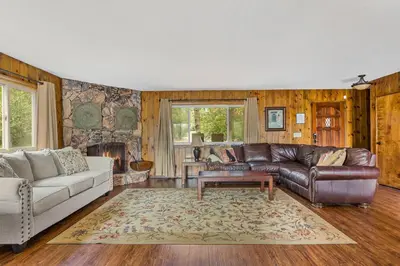 a living room with a couch and a table at Our Secret Getaway - Two Spacious Living Areas in Lake Arrowhead