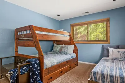 a bedroom with two bunk beds and a window at Our Secret Getaway - Two Spacious Living Areas in Lake Arrowhead