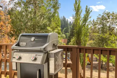 a barbecue grill sitting on a wooden deck at Our Secret Getaway - Two Spacious Living Areas in Lake Arrowhead