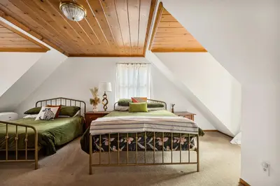 a bedroom with two beds in a attic at Pineland Getaway - Serene Escape in Green Valley Lake