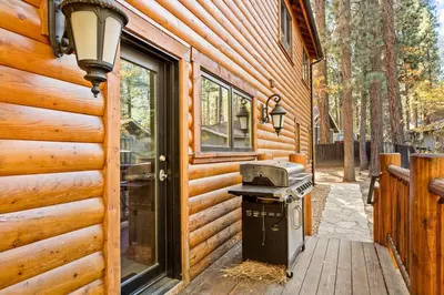 a cabin with a grill outside of a building at Summit Pine Lodge - 2 Minutes to Snow Summit in Big Bear Lake