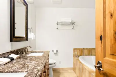 a bathroom with a sink and a tub and a toilet at Summit Pine Lodge - 2 Minutes to Snow Summit in Big Bear Lake