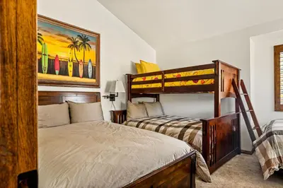 a bedroom with a bed and a bunk bed at The Adler's Nest - Lakefront with Pool Spa and Summer Dock in Big Bear Lake