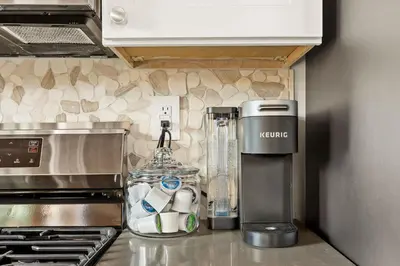 a kitchen counter with a blender next to a stove at The Fancy Fox - Stunning 4 BR Retreat Close to Lake in Lake Arrowhead