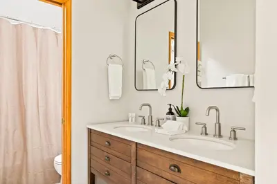 a bathroom with two sinks and two mirrors at The Fancy Fox - Stunning 4 BR Retreat Close to Lake in Lake Arrowhead