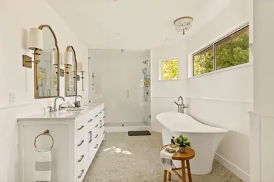 a white bathroom with a tub and a sink at The Lilypad - 2 Master Bedrooms & Game Room in Lake Arrowhead