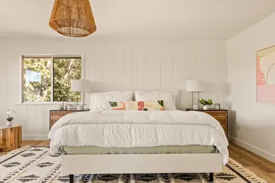 a bedroom with a large white bed with two lamps at The Lilypad - 2 Master Bedrooms & Game Room in Lake Arrowhead
