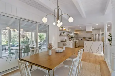 a dining room and kitchen with a wooden table and chairs at The Lilypad - 2 Master Bedrooms & Game Room in Lake Arrowhead