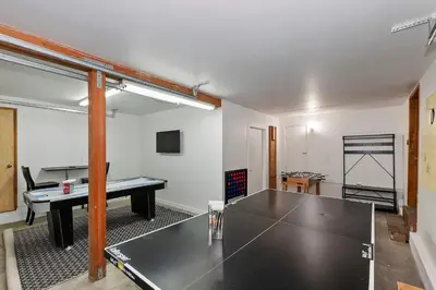a room with a ping pong table in it at Tres Patos - Lakefront Stay for 8 in Green Valley Lake