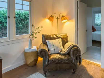 a leather chair in a living room with a lamp at Venice 2BR - Ocean Walk with Stunning Outdoor Space! in Los Angeles
