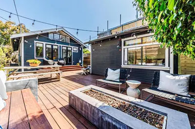 a backyard with a wooden deck with a fire pit at Venice 2BR - Ocean Walk with Stunning Outdoor Space! in Los Angeles